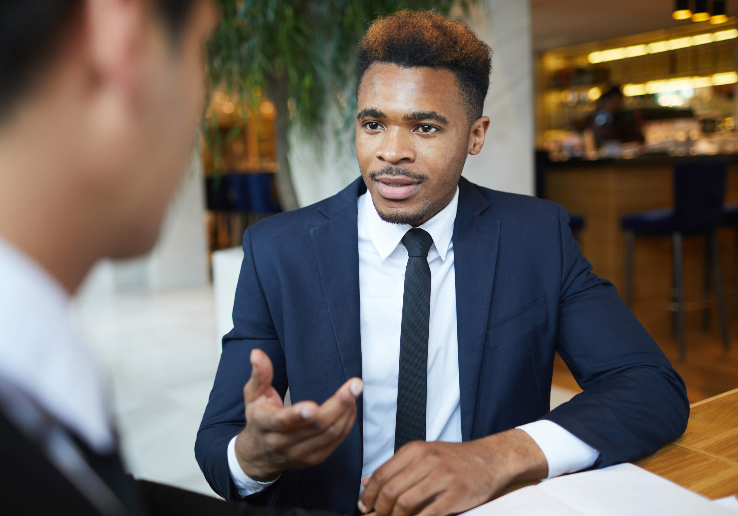 African young businessman has an interview with business partner in informal setting